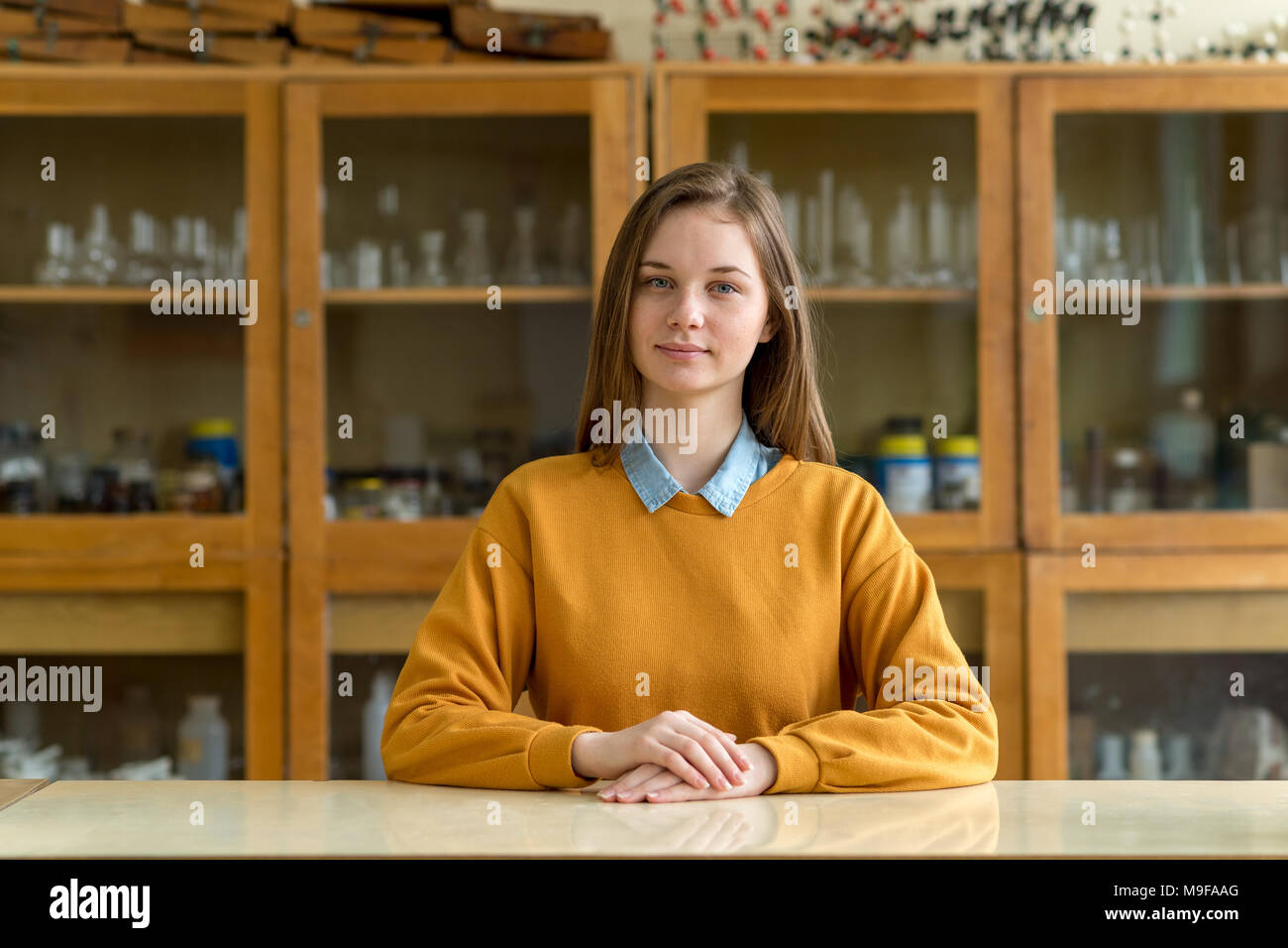 Portrait of young female college student in chemistry class. Focused student in classroom. Authentic Education concept. Stock Photo