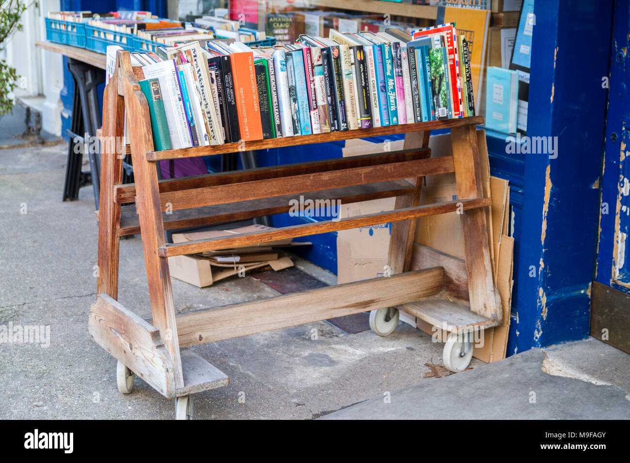 Books on an Old fashioned book trolley bookstore with crates