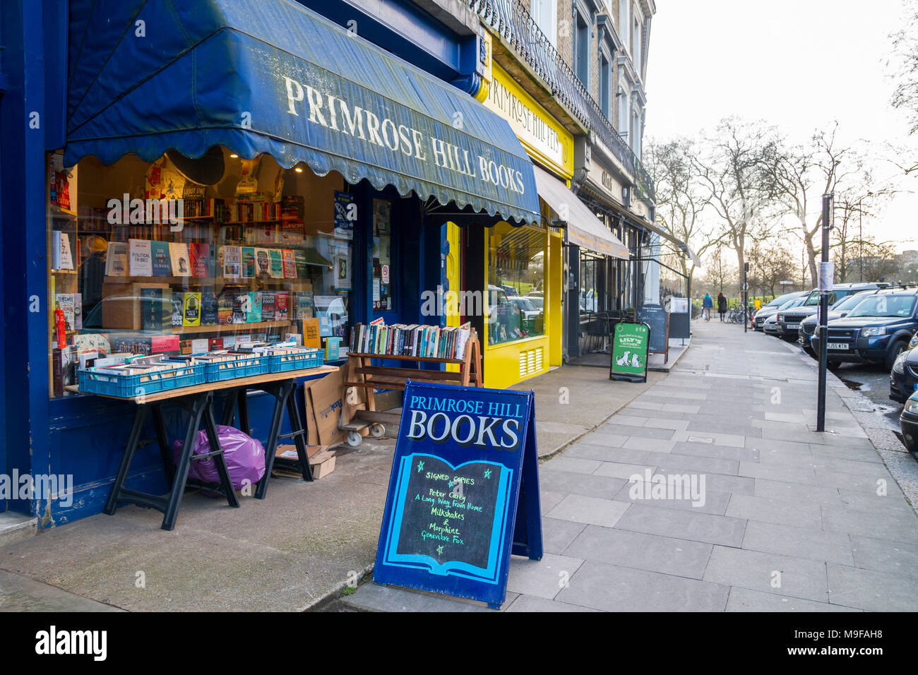 Primrose Hill Books, traditional bookshop, bookstore book shop with crates of secondhand books outside stacked, London UK learning knowledge education Stock Photo