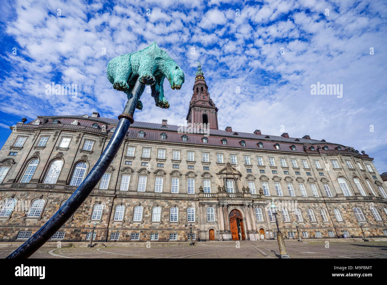 Denmark, Zealand, Copenhagen, copper sculpture of a polar bear impaled by an oil pipeline, titled 'Unbearable' by Jens Galschiot with view of Christia Stock Photo