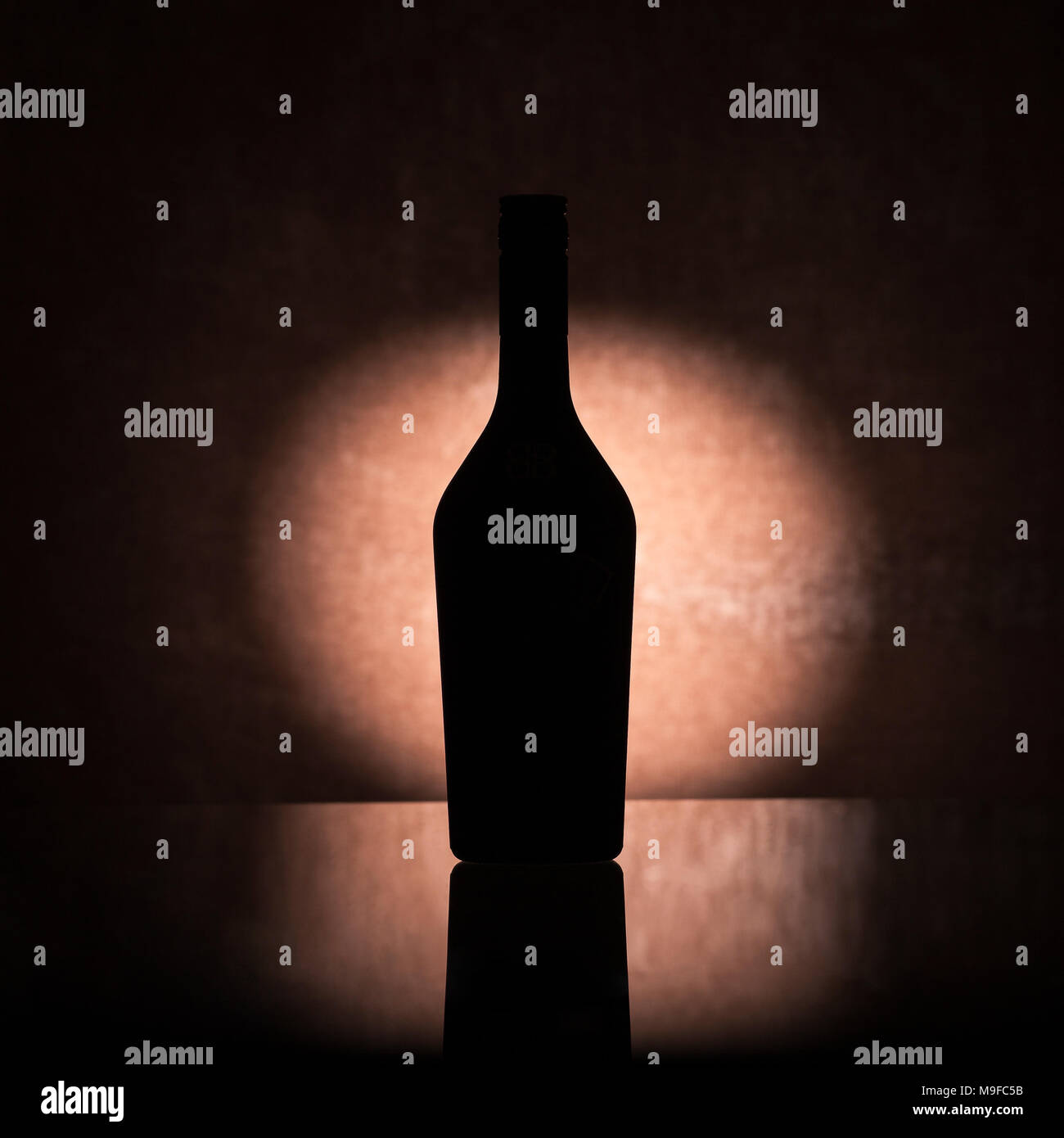 Backlit liquor bottle, silhouette in the shade Stock Photo - Alamy