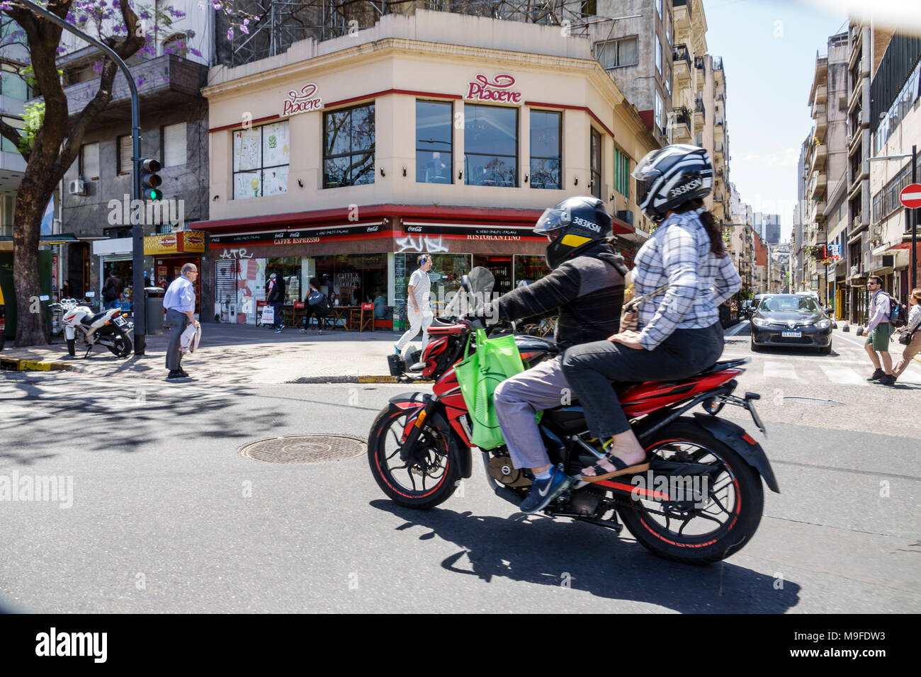 Buenos Aires Argentina,traffic,adult adults man men male,woman women female lady,street,motorcycle motorcycles,riding,two-up rider,helmet,adult adults Stock Photo