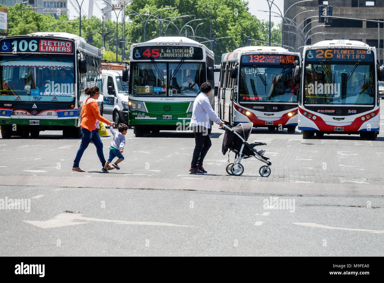 Buenos Aires Argentina,Retiro,bus,public transportation,street crossing,pedestrian,adult adults man men male,woman women female lady,boy boys,kid kids Stock Photo