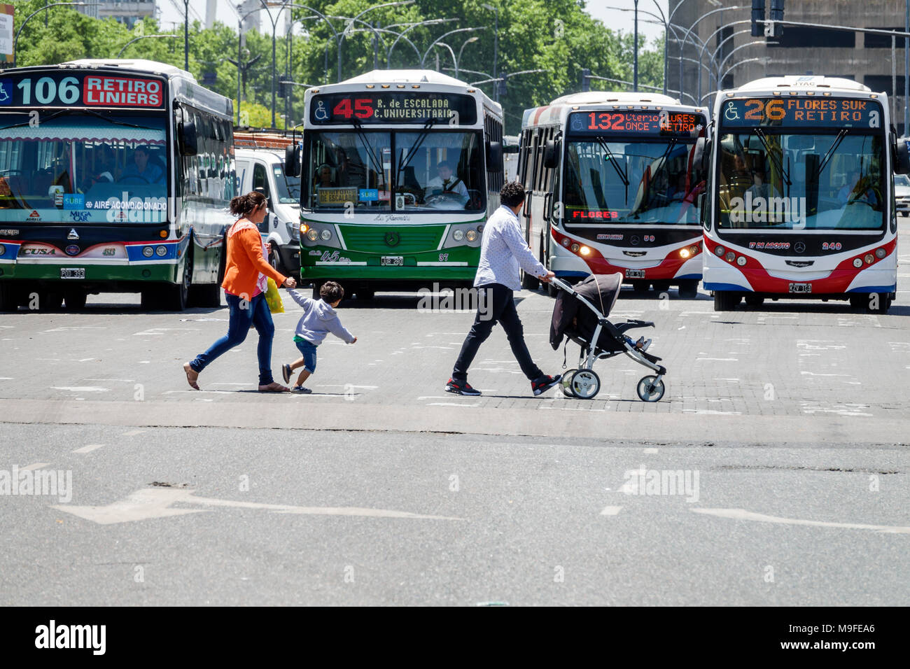 Buenos Aires Argentina,Retiro,bus,street crossing,pedestrian,man men male,woman female women,boy boys,kid kids child children youngster,stroller,famil Stock Photo