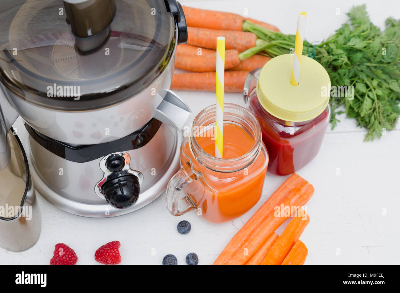 Preparing juice from fresh fruits and vegetables. Electric juicer