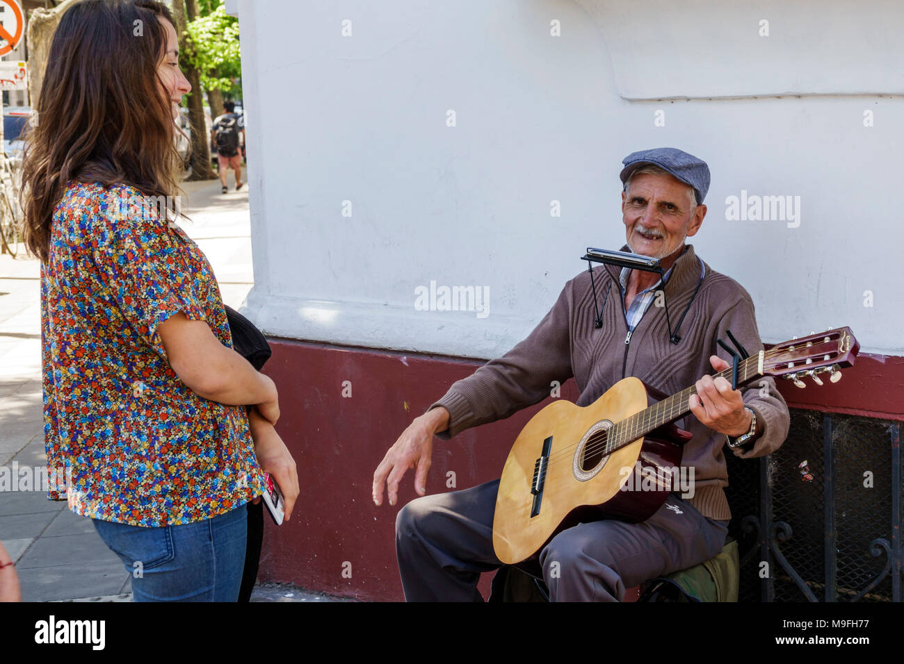 Buenos Aires Argentina,Belgrano,street performer,musician,guitar,harmonica,adult adults man men male,woman women female lady,visitors travel traveling Stock Photo