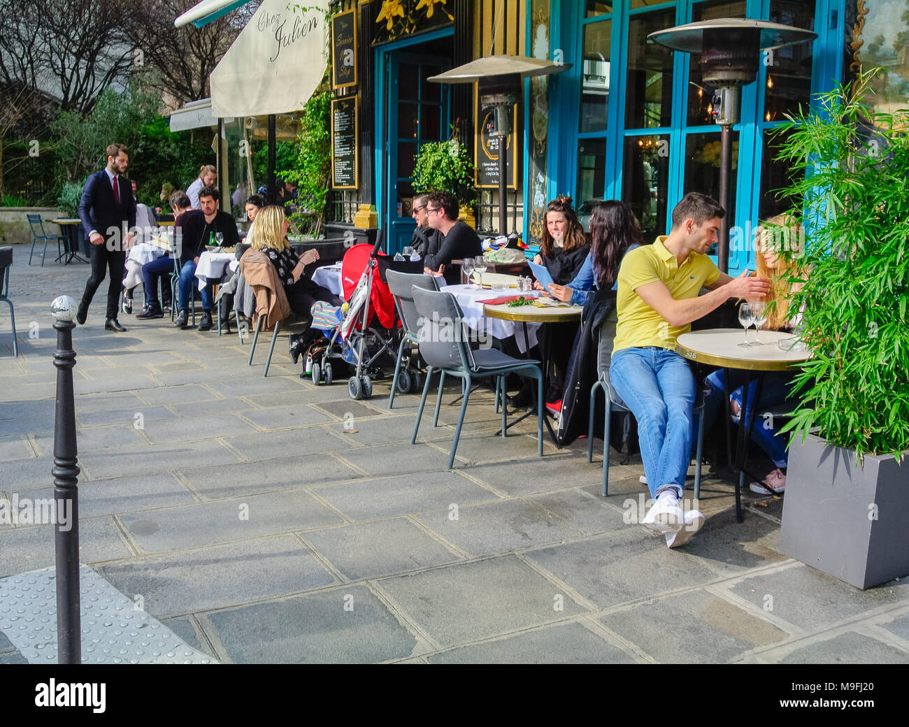 French people at a terrace of cafe in the street, Paris, France Stock Photo