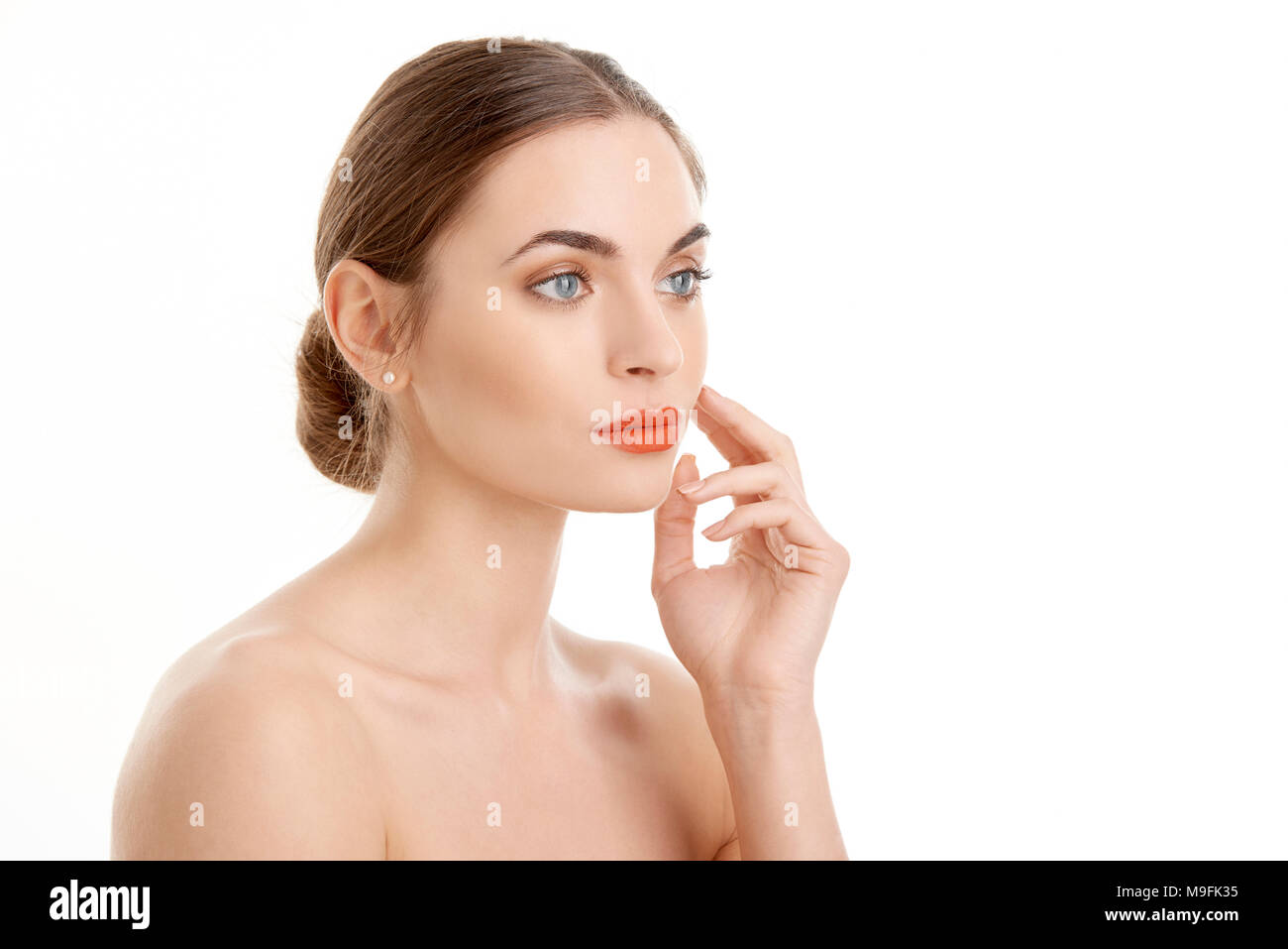 Half face profile of beautiful young woman with red lipstick looking away while standing at