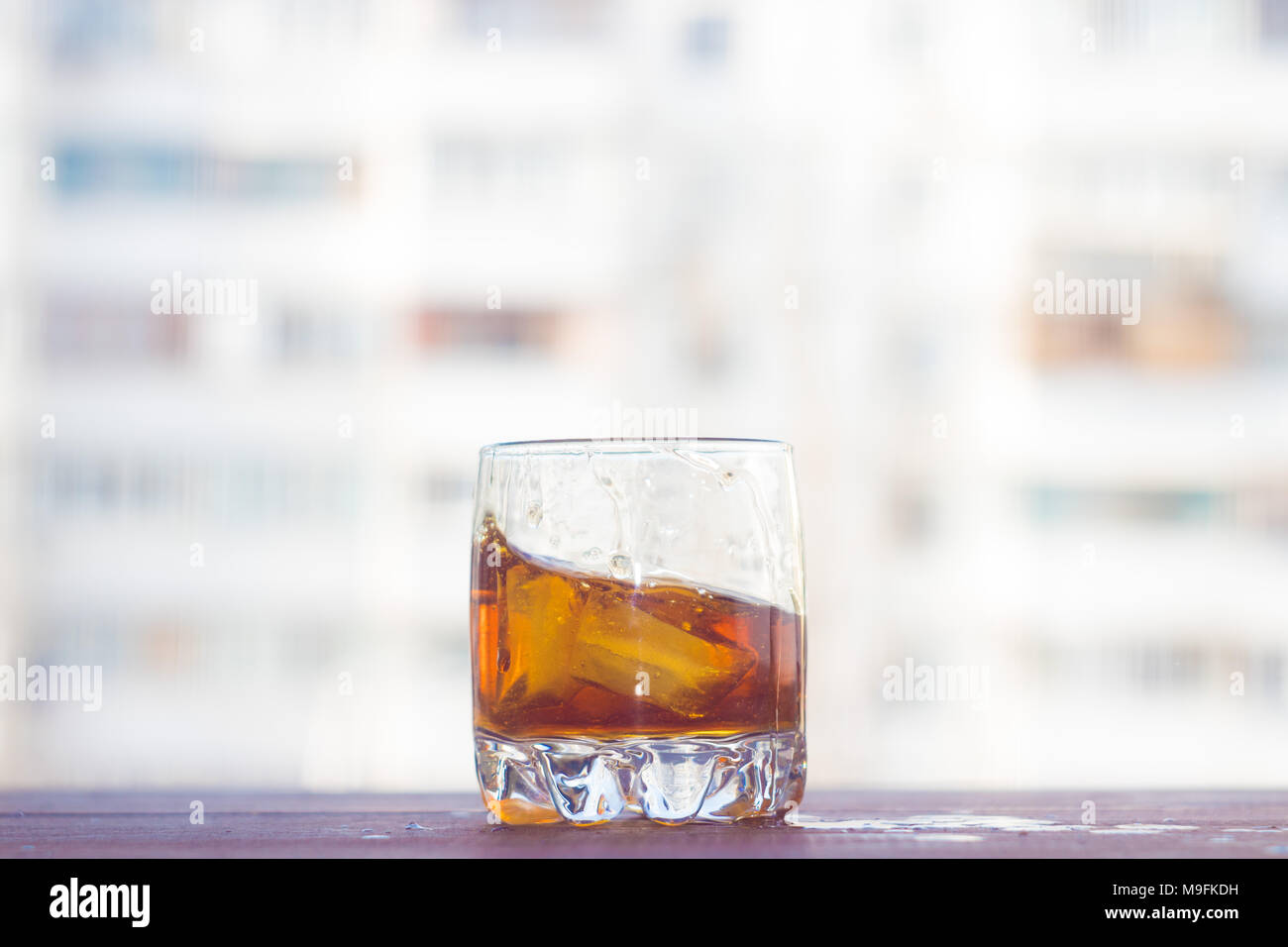 A glass of whiskey with ice. Cognac with ice Stock Photo