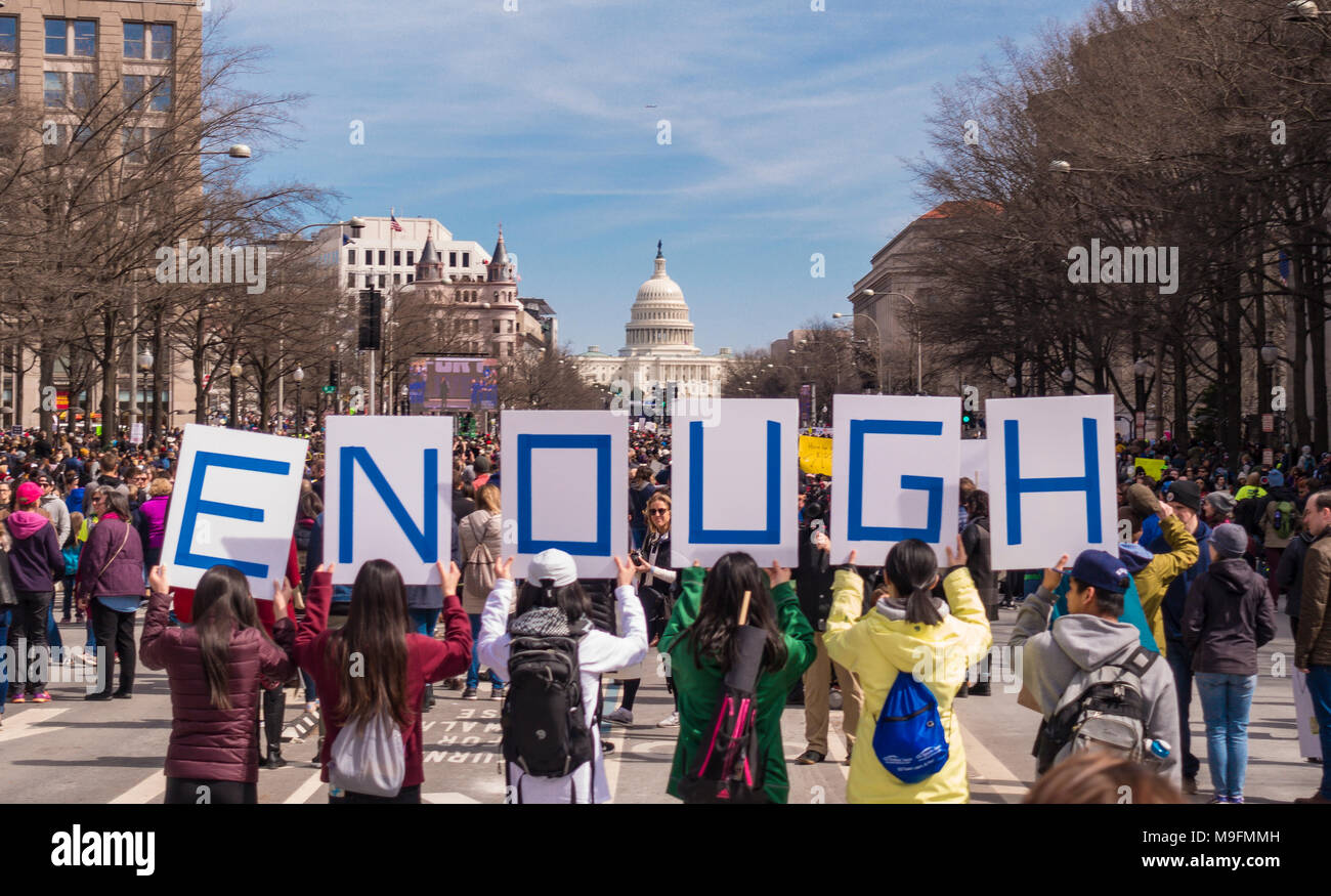 WASHINGTON, DC, USA - March for Our Lives demonstration, protesting gun violence. People hold ENOUGH signs. Stock Photo