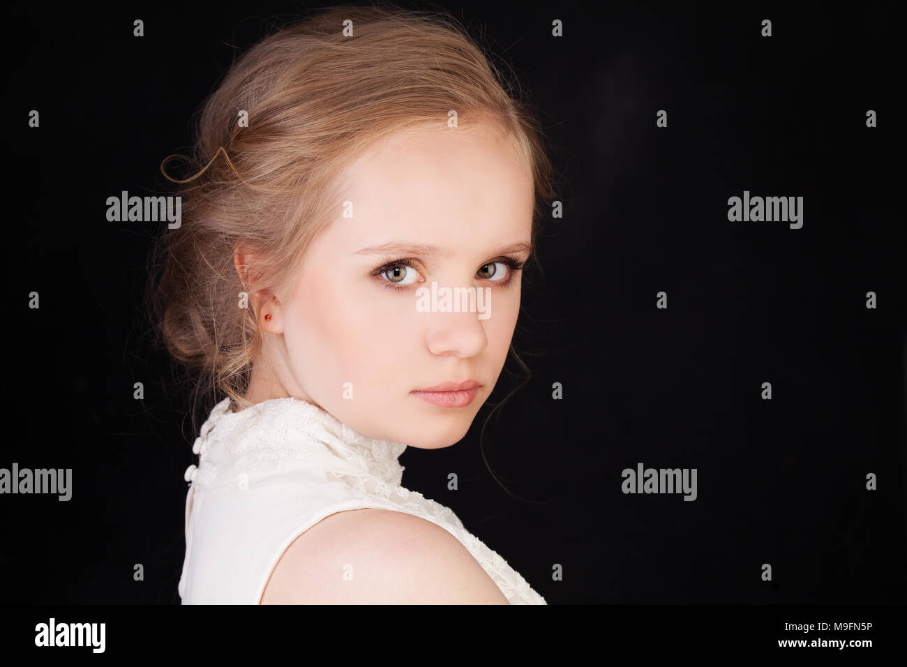 Young Face Cute Girl With Blonde Hair On Black Background Stock