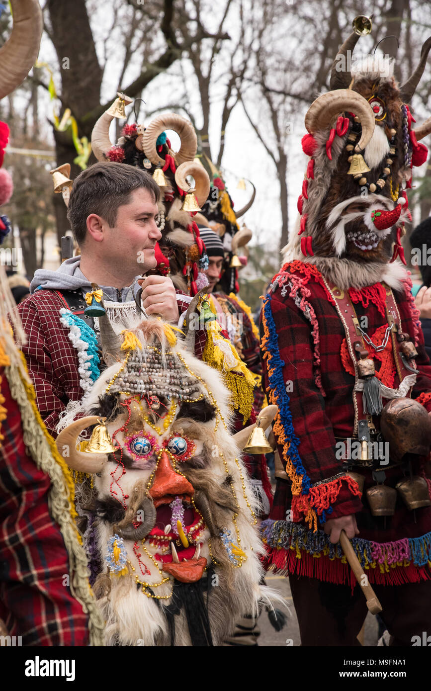 People in traditional carnival costumes at Kukeri festival kukerlandia Yambol, Bulgaria. Participants from Moldova Stock Photo