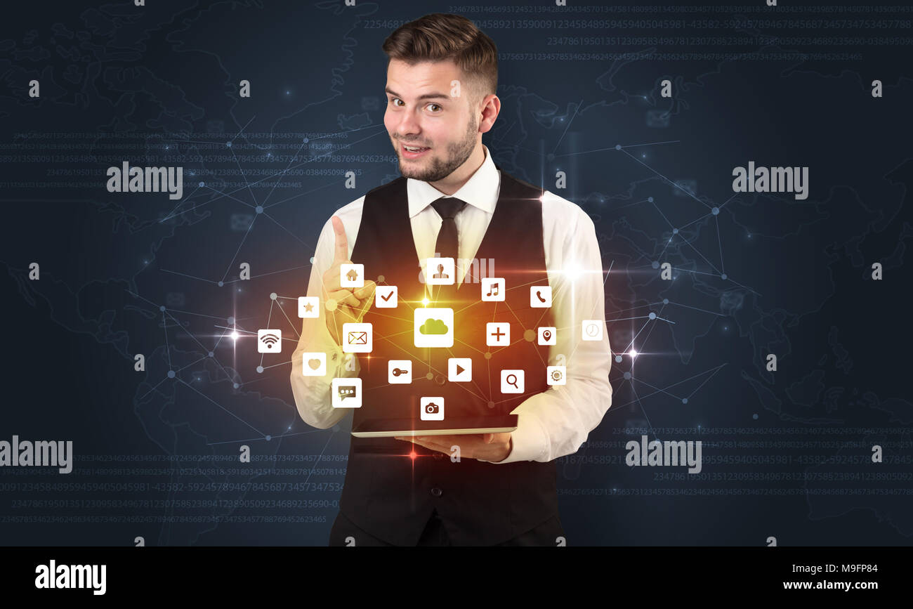 Handsome businessman in suit with tablet on his hand and application ...