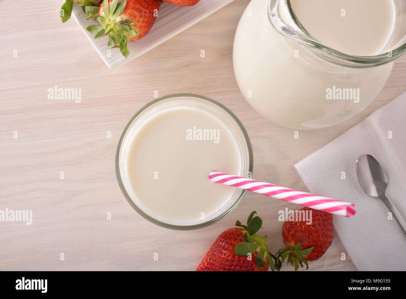 Breakfast milk and strawberries on a white wooden kitchen table. Horizontal composition. Top view Stock Photo