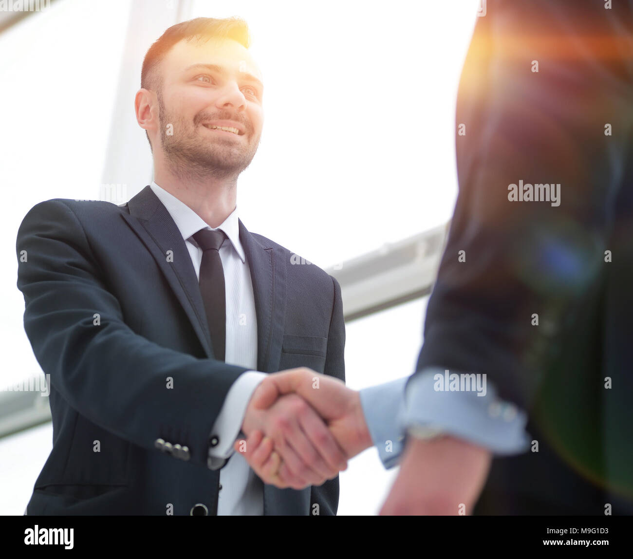 handshake of business partners after a favorable trade deal Stock Photo ...