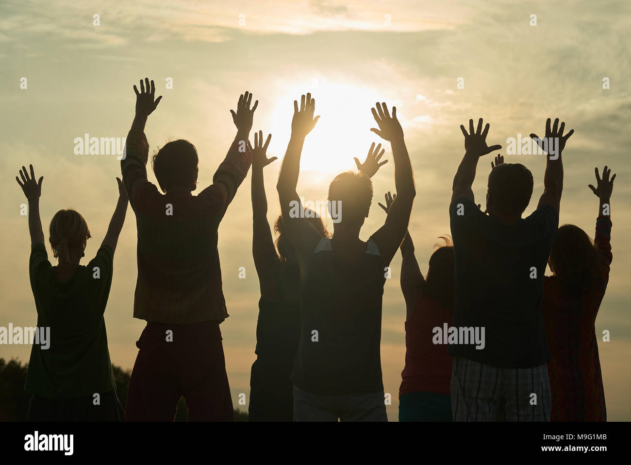 People are dancing at open-air rave live concert. People spreading ...