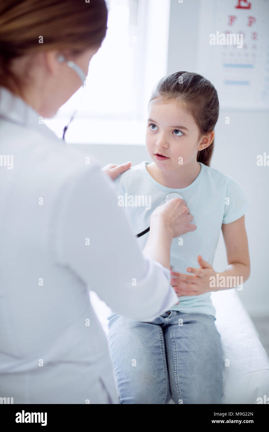 Tender female doctor making diagnosis Stock Photo