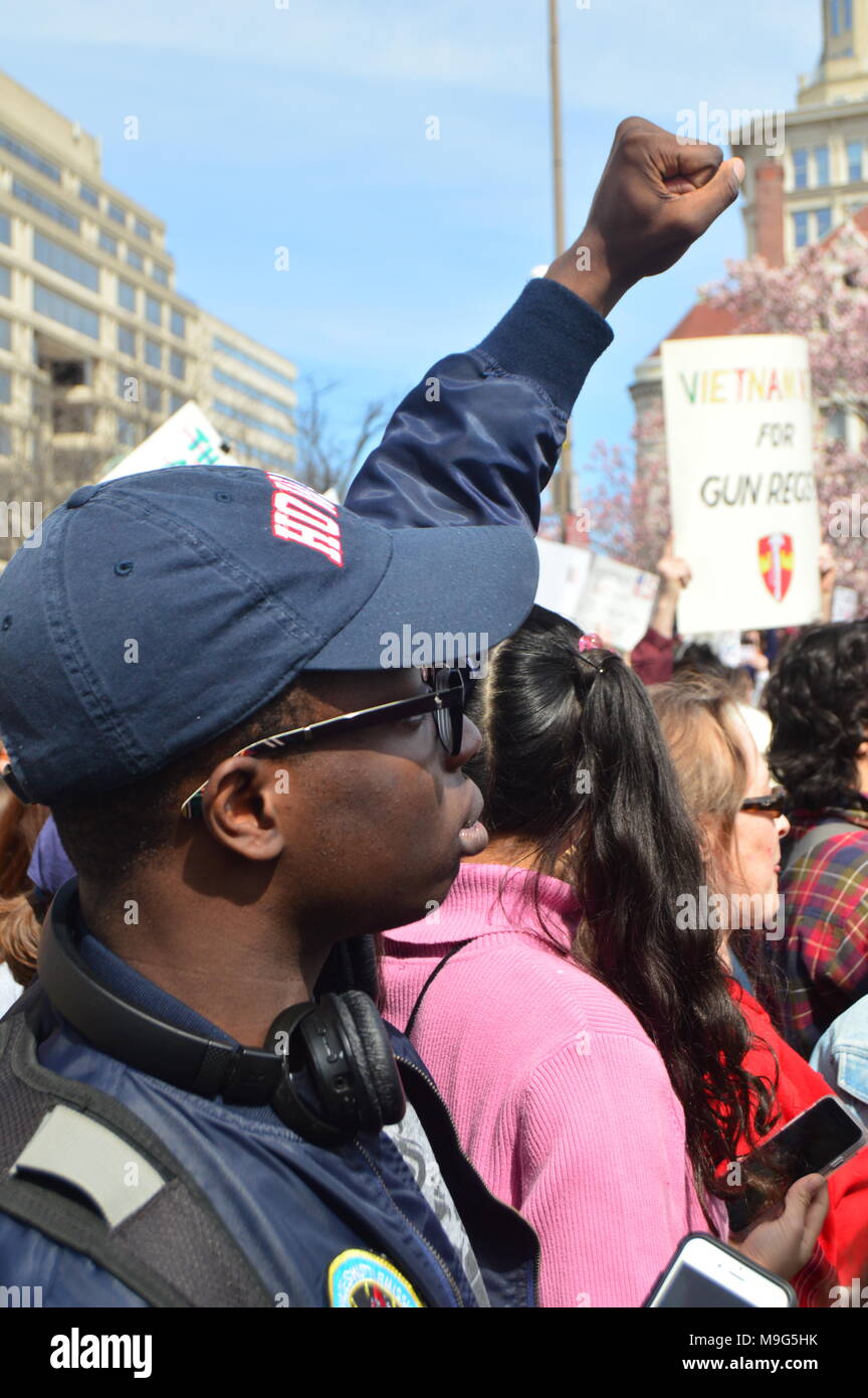 Washington, DC, USA. 24th Mar, 2018. A young African American man raises his hand in support of the March for our Lives in Washington, DC Credit: James Kirkikis/Alamy Live News Stock Photo