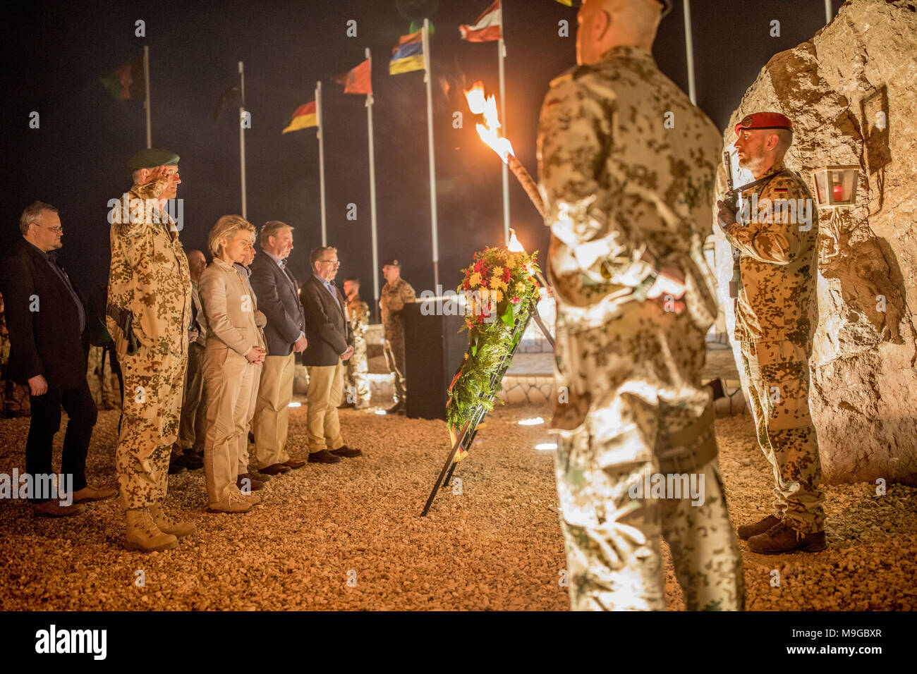 25 March 2018, Afghanistan, Masar-i-Scharif: Defence Minister Ursula von der Leyen from the Christian Democratic Union (CDU, 3L) standing next to General Wolf-Juergen Stahl (2L) and members of the Bundetag defence committee at a remembrance of the fallen soliders at the military camp Marmal. Photo: Michael Kappeler/dpa pool/dpa Stock Photo