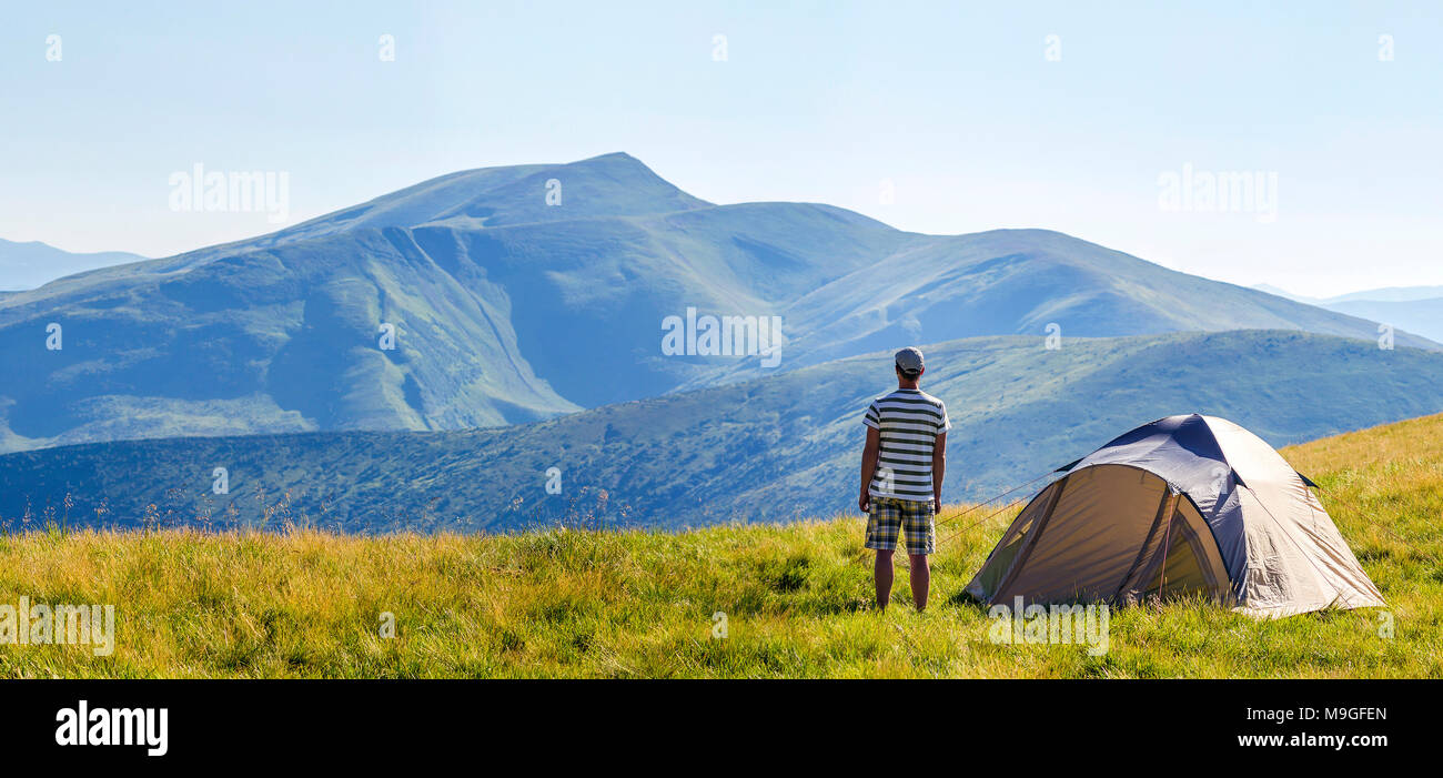 Curated visual reference: Visual Reference: Hiker Man Standing Near Camping Tent In Carpathian Mountains Tourist