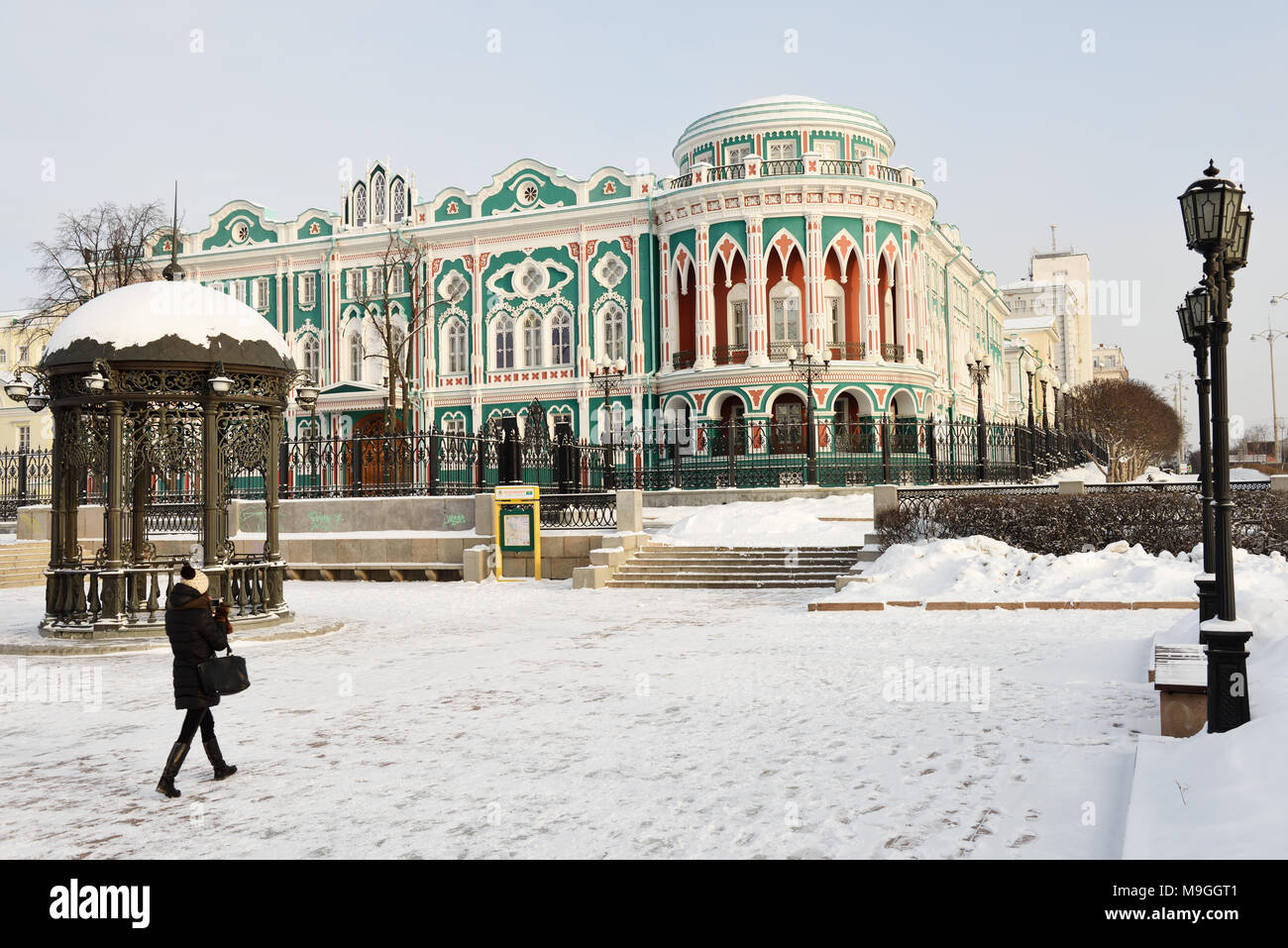 Yekaterinburg, Russia - January 1, 2015: Girl make photo of the house of N. I. Sevastianov. Built in the first quarter of XIX century Stock Photo