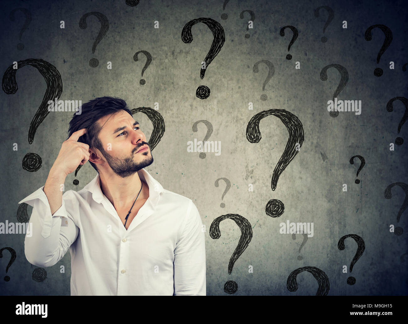 Thoughtful confused handsome man has too many questions and no answer Stock Photo