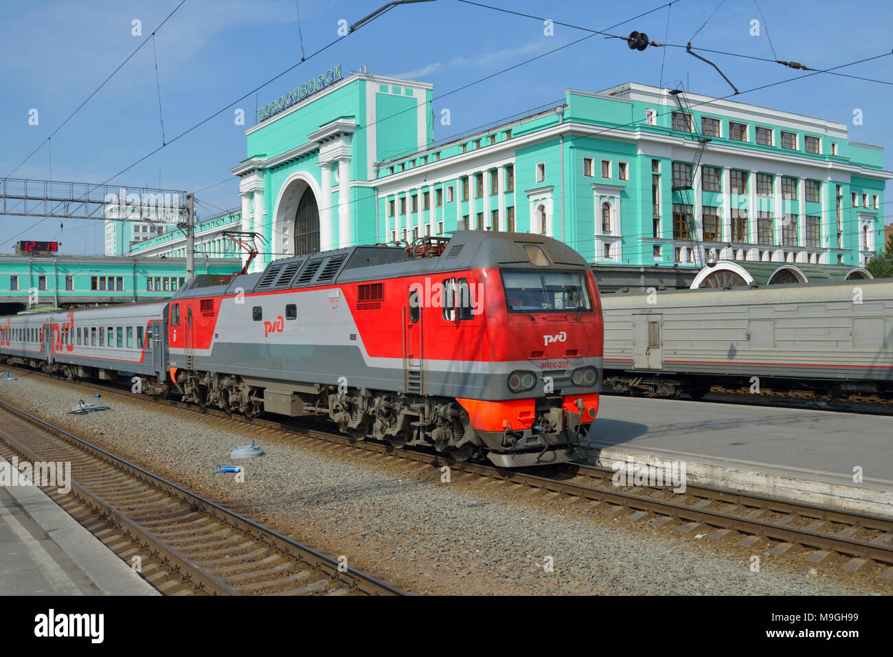 Novosibirsk, Russia - August 25, 2014: Passenger train arriving on the main railroad station of Novosibirsk. The building completed in 1939 and can ac Stock Photo