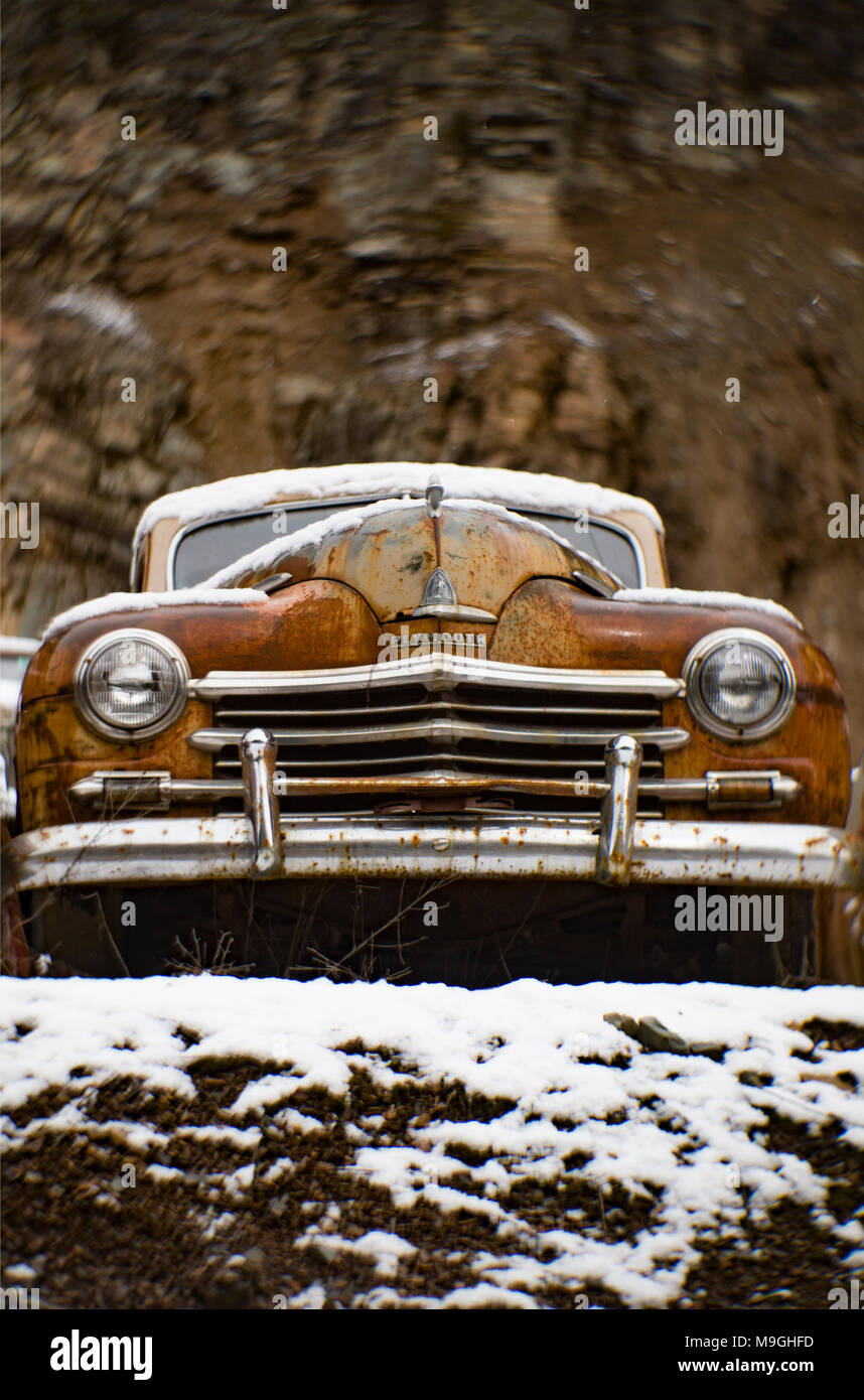The front of an old, rusty 1946 Plymouth Special Deluxe sedan, in an stone quarry, east of Clark Fork Idaho. Stock Photo