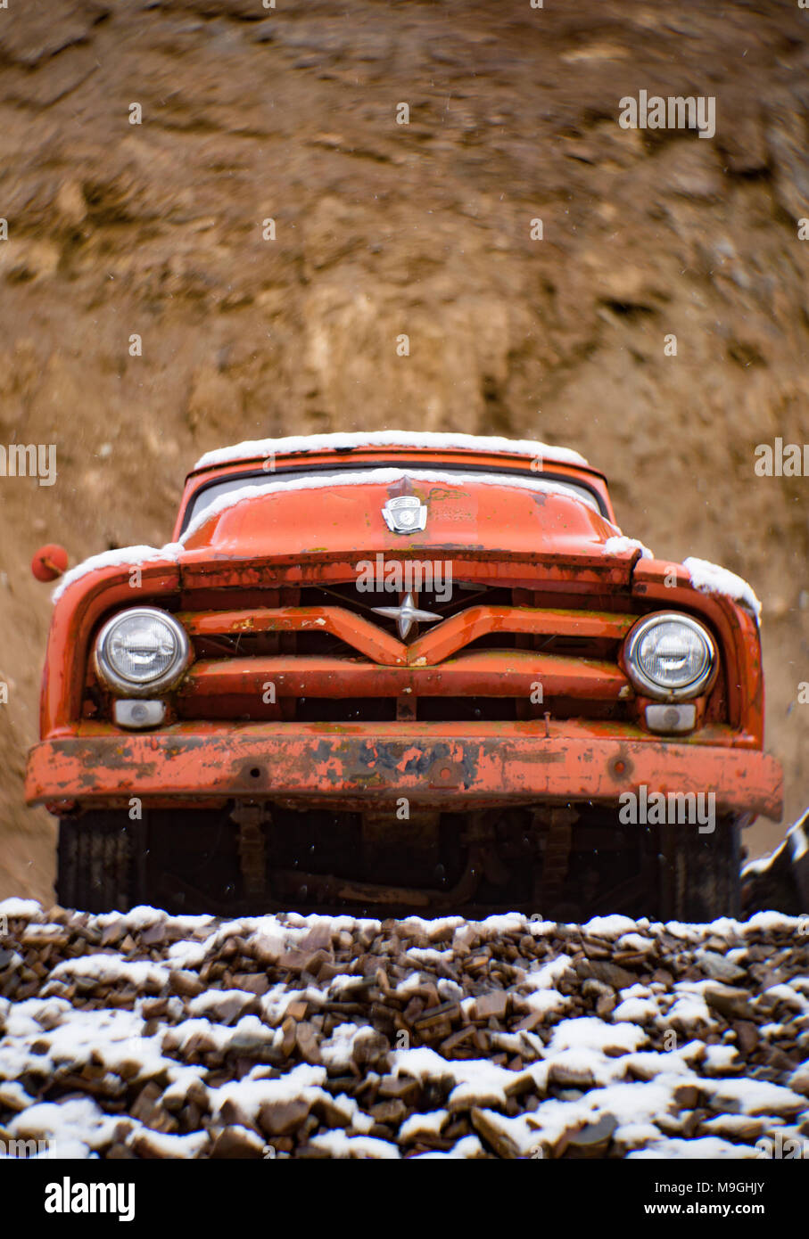 The front of an old, red 1955 Ford F-500 farm truck, in a stone quarry, east of Clark Fork Idaho. Stock Photo