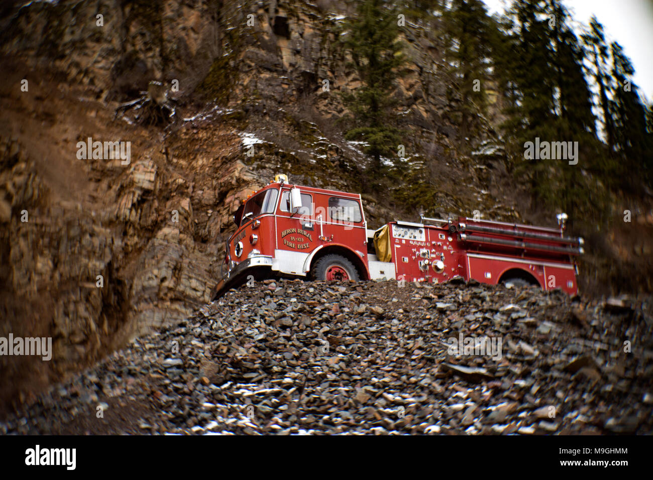 A red 1974 Western Star cabover fire truck atop of a rock pile, in an old stone quarry, east of Clark Fork Idaho. Stock Photo