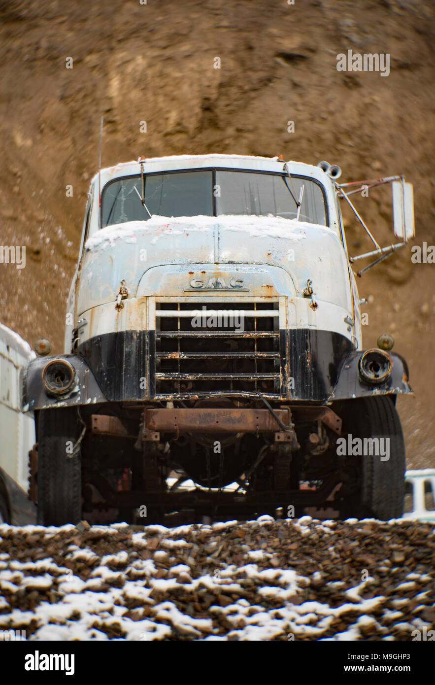 A white 'Cannonball' 1956 GMC 630 cabover truck, in an old quarry, east of Clark Fork Idaho. Stock Photo