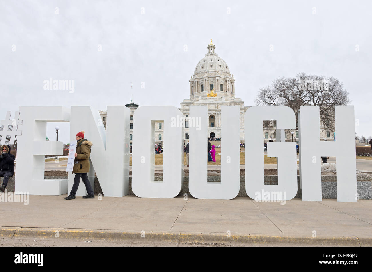 St. Paul, MN, USA – MARCH 24, 2018: Protester holds sign on State Capitol mall moments before students’ arrival during March For Our Lives rally. Stock Photo