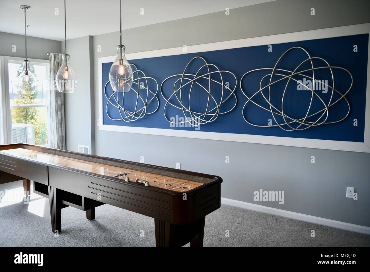 Modern family room with a shuffleboard game inside a new construction home Stock Photo