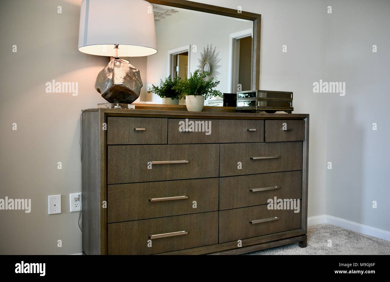 View Of Bedroom Dresser Inside A Decorated Modern Home Stock Photo