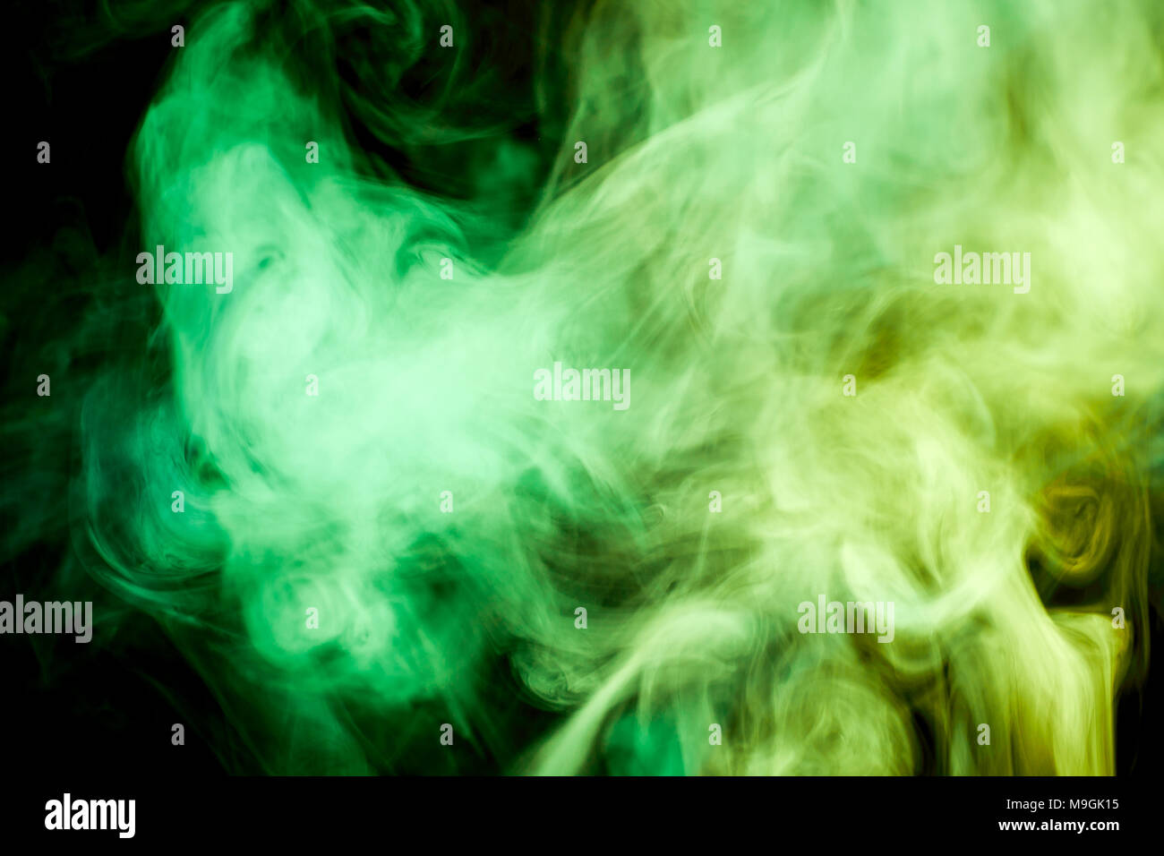 Colorful green smoke on a black isolated background. Background from the  smoke of vape Stock Photo - Alamy