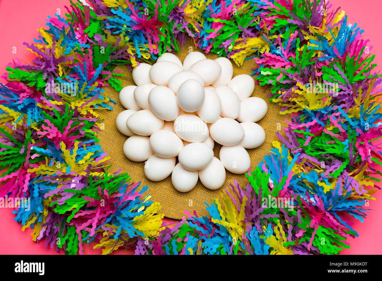 Nice plate of 2 dozen uncolored Easter eggs with pastel color background. Stock Photo