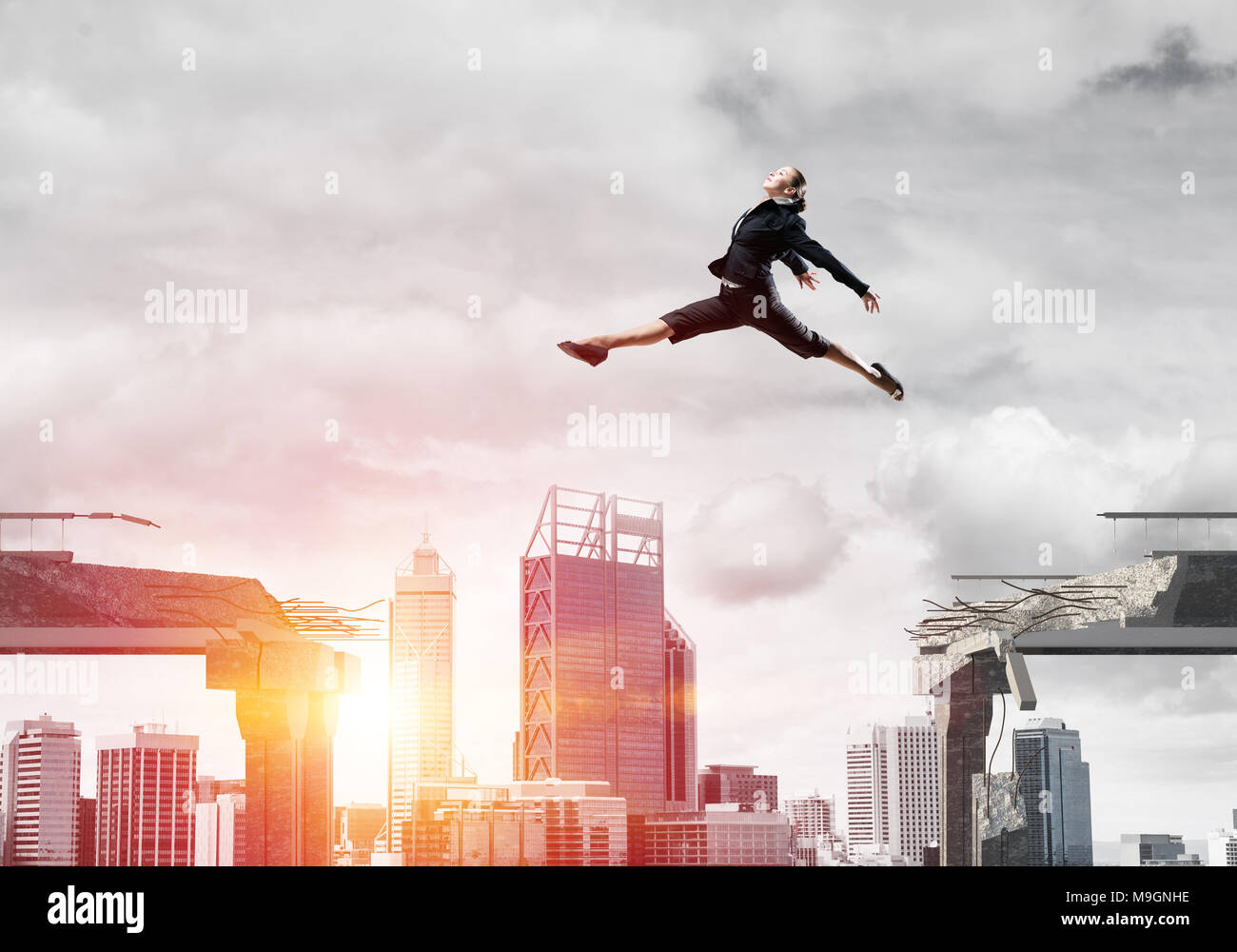 Business woman jumping over gap in concrete bridge as symbol of ...