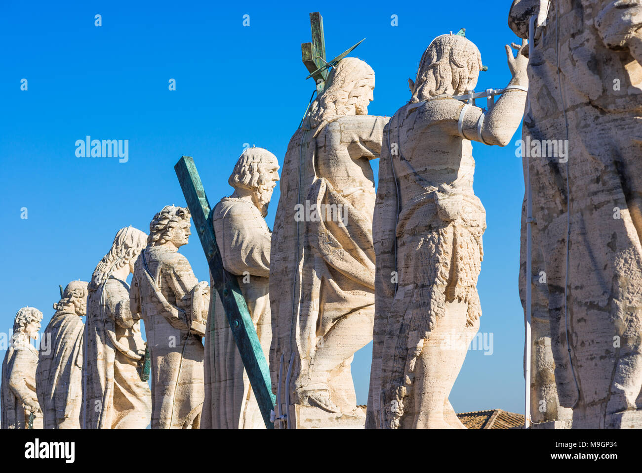 Jesus Christ statue with his 12 disciples at the top of St Peter's Cathedral, Vatican city, Rome, Lazio, Italy. Stock Photo