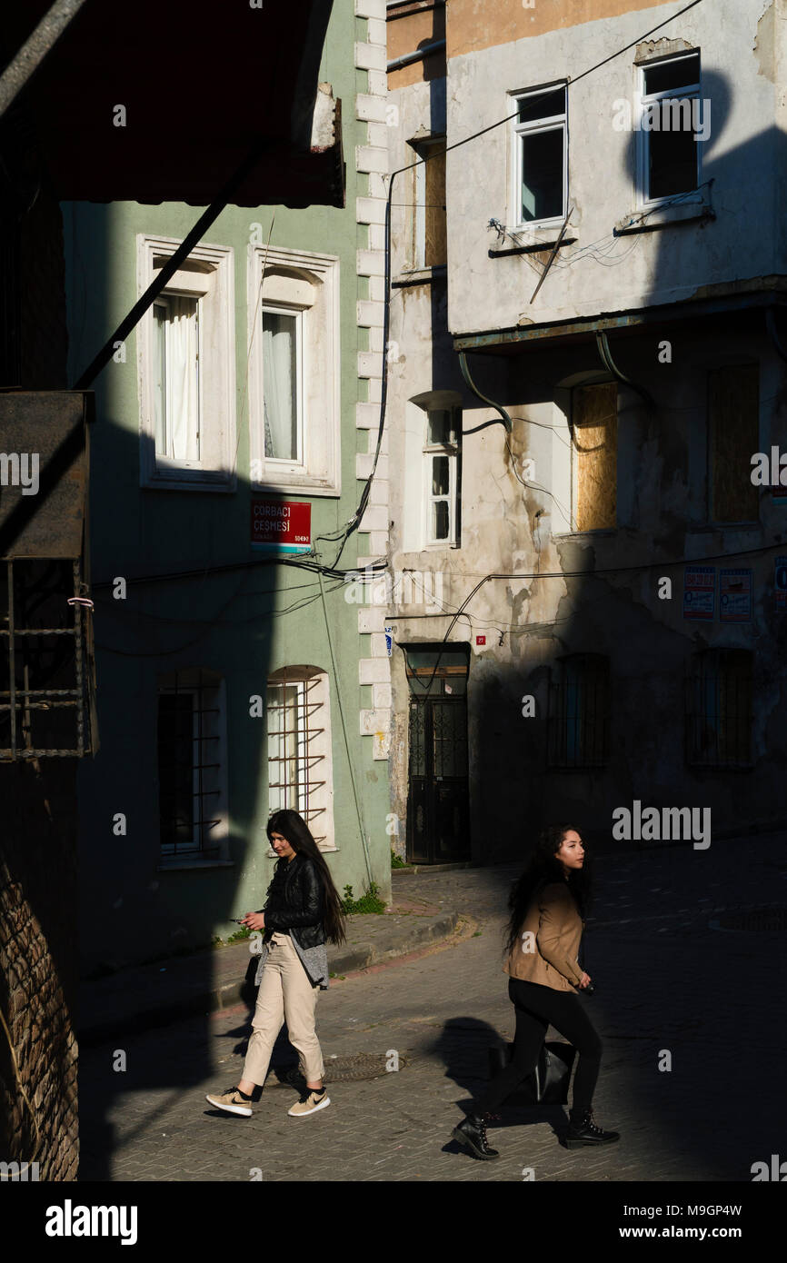 Istanbul, Turkey - March 15, 2018 : Turkish modern young women are walking at the Istanbul, Balat District. One of them is a photographer and she has Stock Photo