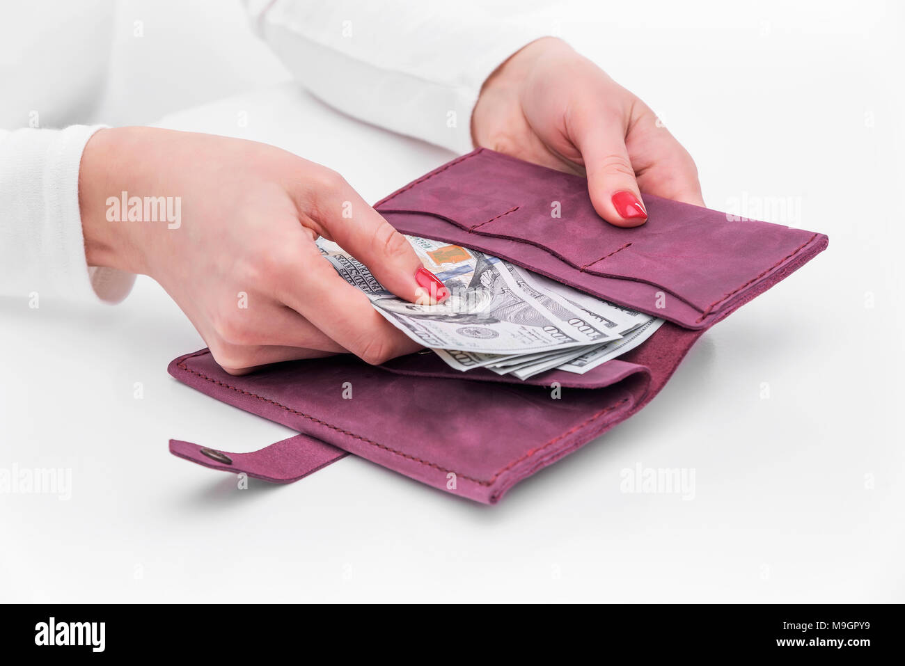 Purse with money in female hands. Stock Photo