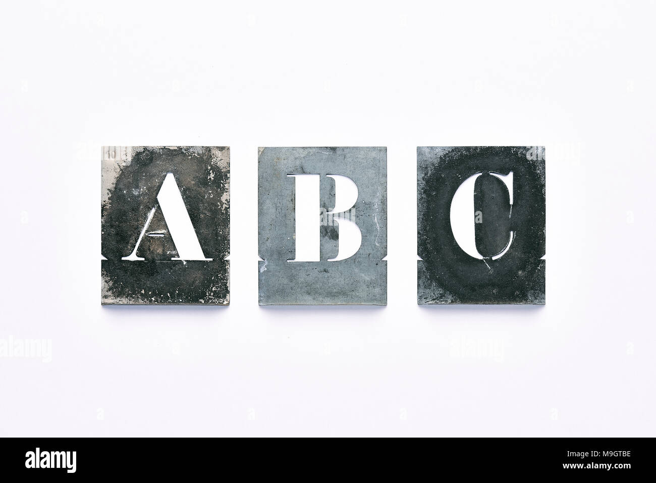 Metal letter stencil A, B, C on  white background Stock Photo