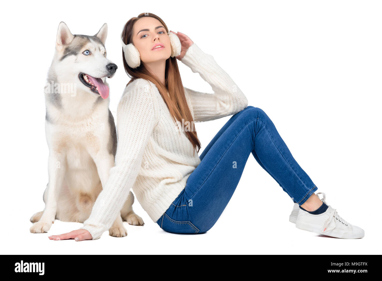 beautiful woman talking on smartphone while husky dog sitting near, isolated on white Stock Photo