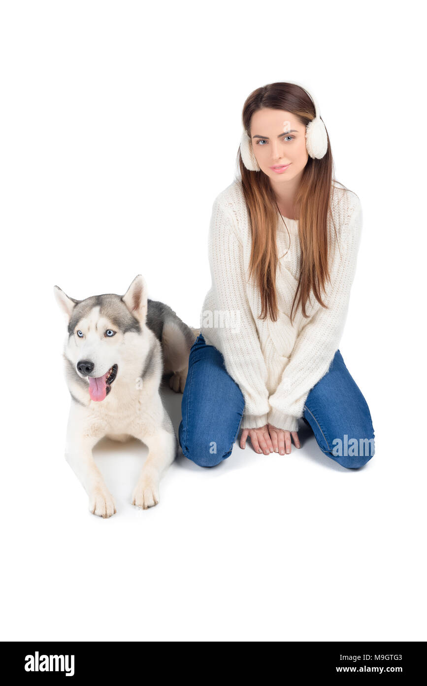 beautiful woman talking on smartphone while husky dog sitting near, isolated on white Stock Photo