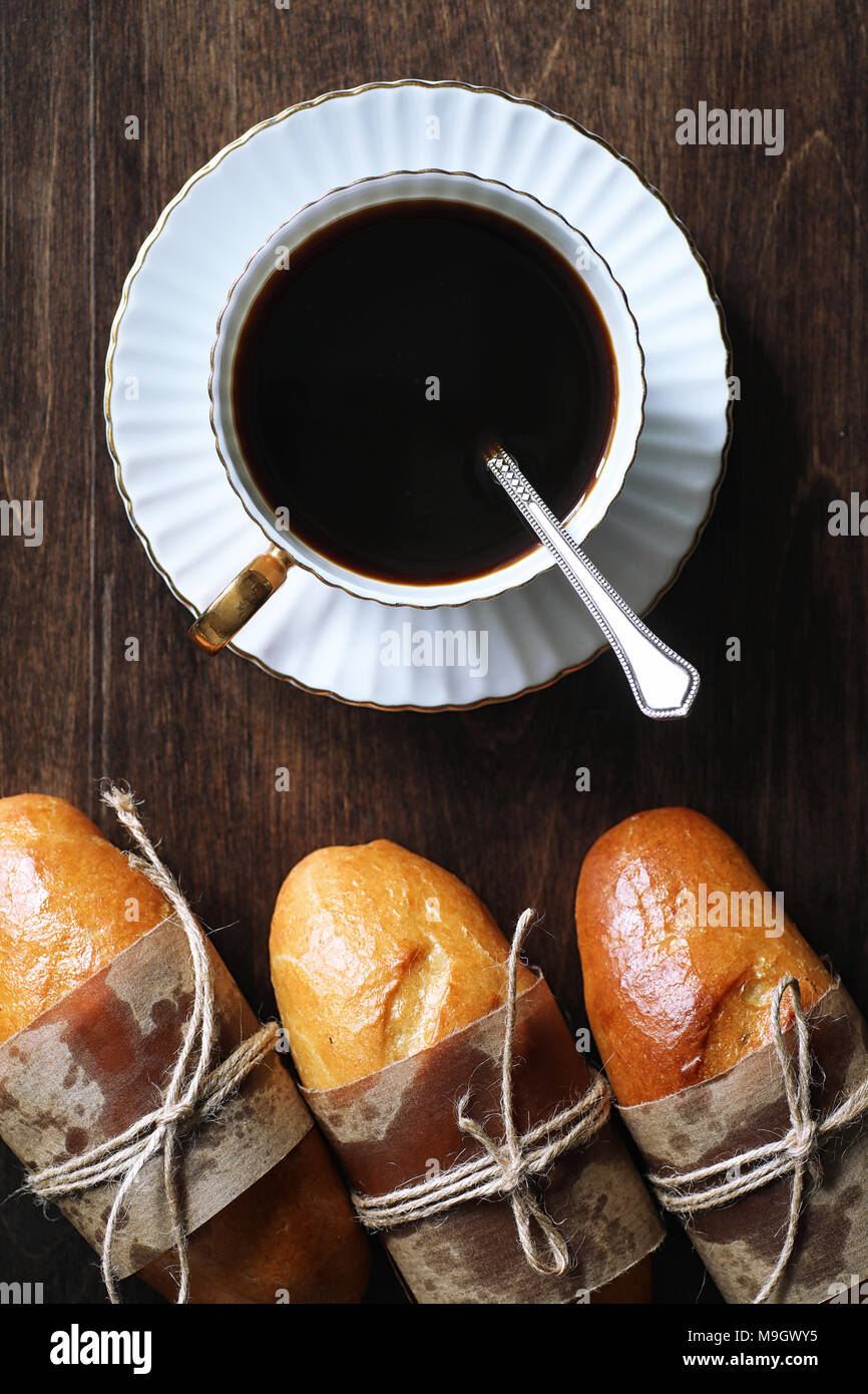 Freshly baked French baguette on a wooden table Stock Photo - Alamy