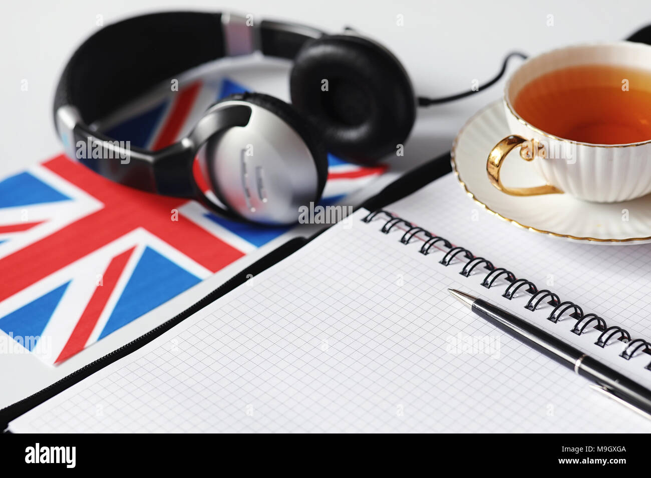 Learning foreign languages. Notepad for entries and a flag. Lang Stock