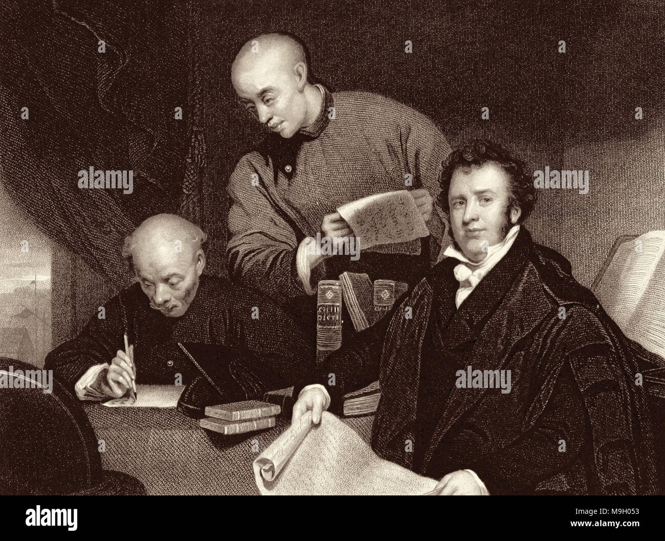 Li Shigong (left), Chen Laoyi (center) and pioneering Protestant missionary Robert Morrison (right) translating the Bible into Chinese. This engraving by W. Holl, c1850s, is based on George Chinnery's now-lost c1828 original painting, which was burned in a fire in 1874. Stock Photo