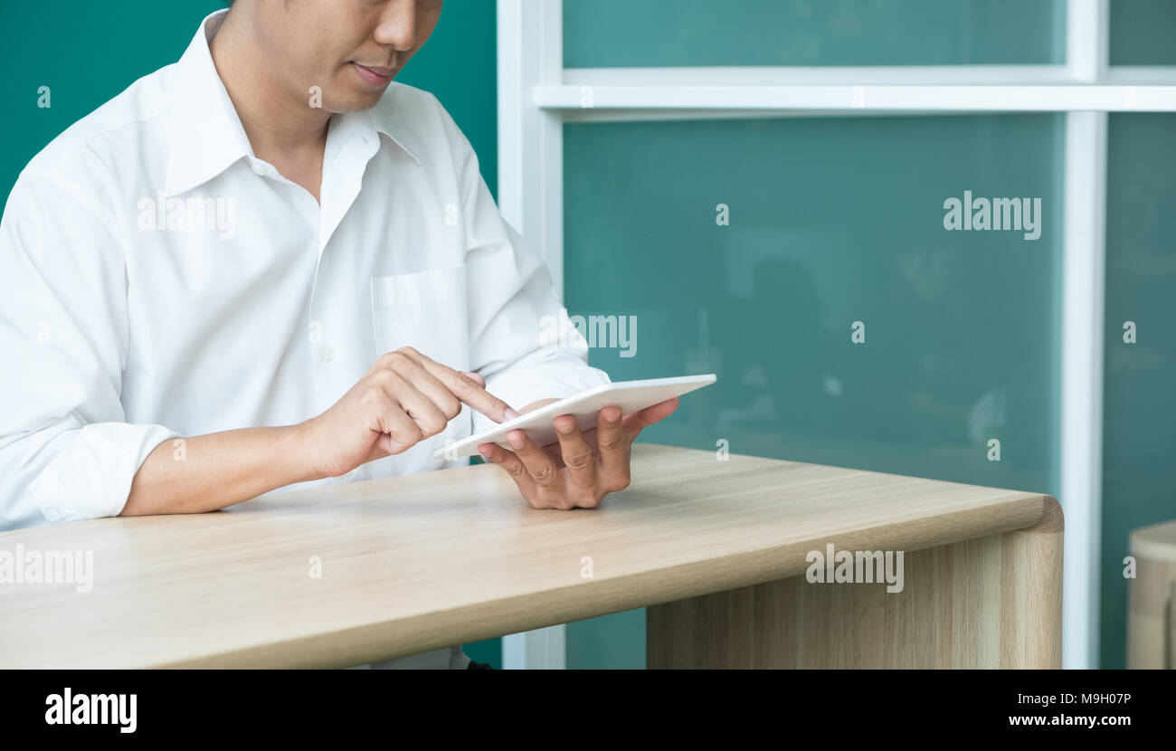 businessman using tablet computer on desk at office,after working at evening Stock Photo