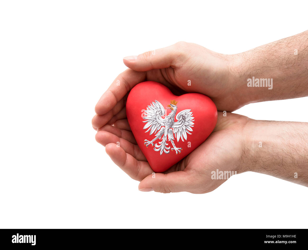 Hands covering Polish coat of arms on a red heart isolated on white background. Clipping path included. Stock Photo