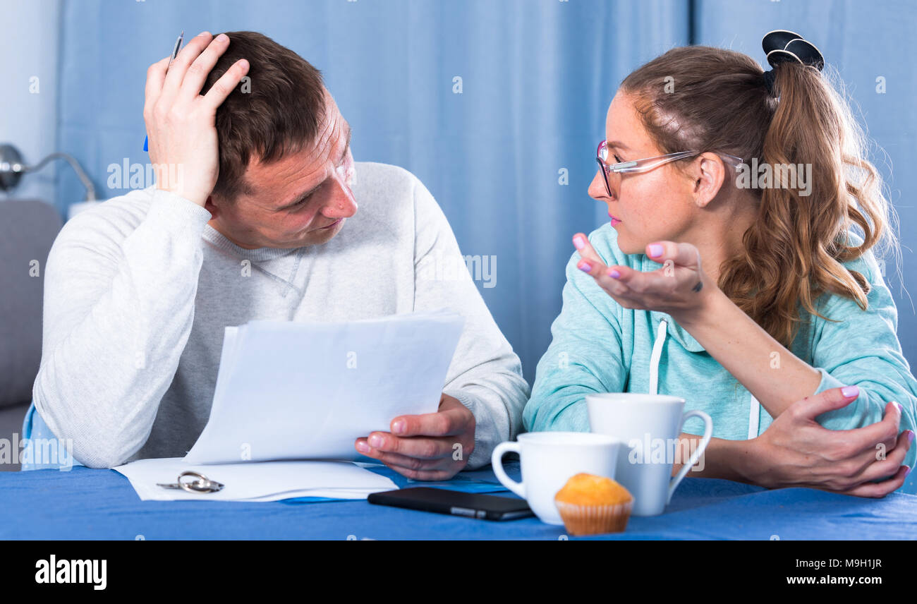 Middleaged family struggling to pay utility bills and rent for their