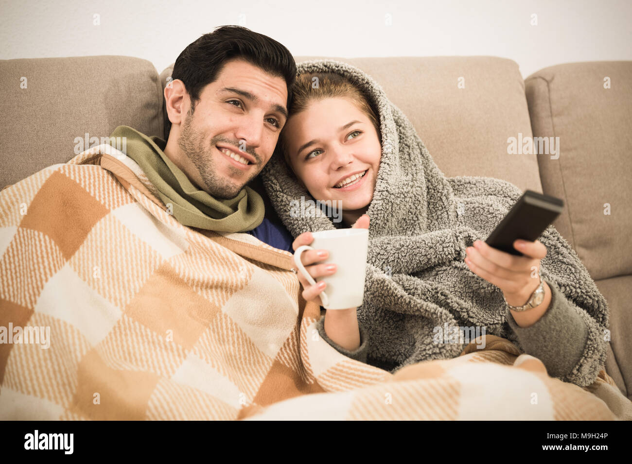 Snuggling on sofa watching tv hi-res stock photography and images - Alamy